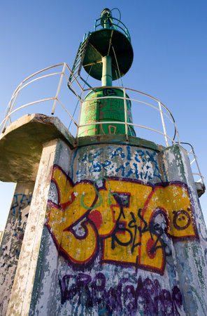 Pescara, Italy - September 4, 2006: A beacon with graffiti on the breackwater of the harborのeditorial素材