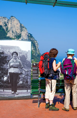 Capri, Italy - April 22, 2007: Young tourists near a picture of a tourist of the past in the lookout area of the Marina Grande old villageのeditorial素材