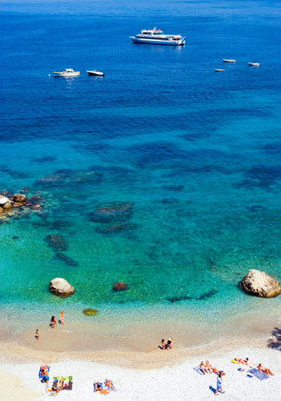 Capri, Italy - April 22, 2007: Tourists sunbathing on the Marina Grande beachのeditorial素材