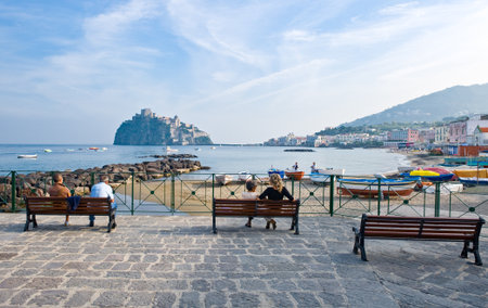 Ischia, Italy - October 19, 2008: People looking at the Aragonese castle from the Dei Pescatori beachのeditorial素材