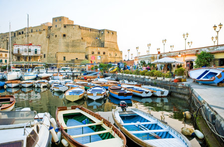 Naples, Italy - April 21, 2006: Sunset view of the Castel Dell'Ovo fortress with the marina in the foregroundのeditorial素材