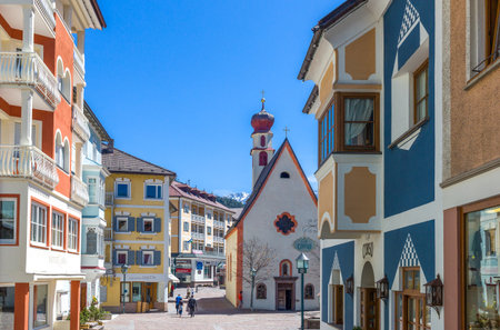 Ortisei, Italy - April 28, 2012: Yhe houses and the parish church of the historic town centerのeditorial素材