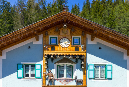 Canazei, Italy - April 26, 2012: The facade of a traditional house with clock.のeditorial素材