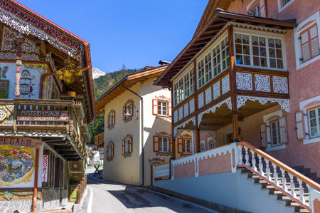 Canazei, Italy - April 26, 2012:  Traditional fully decorated houses in the old villageのeditorial素材