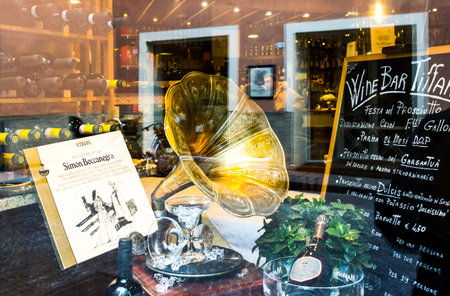 Parma, Italy - November 28, 2013:  Beverages and opera music in a wine bar window