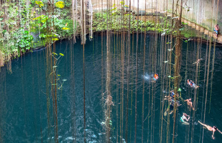 Chichen Itza , Mexico - April 18, 2016: Tourists bathing in the Ik Kil sinkholeのeditorial素材