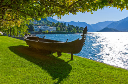 Italy, Bellagio, a traditional boat on the Como lake frontの写真素材