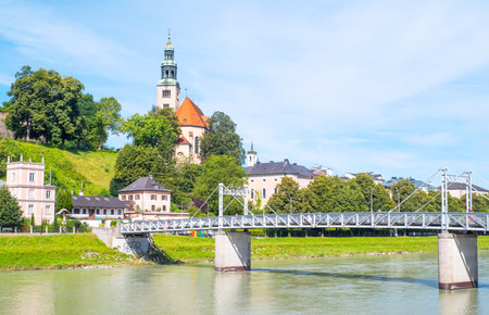 Salzburg, Austria - August 3, 2016:  View of the Hllner church and quarter on the Salzach river bankのeditorial素材