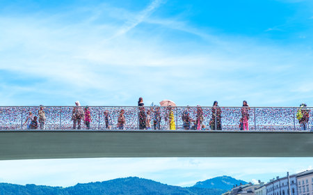 Salzburg, Austria - August 3, 2016:  People crossing a bridge on the Salzach riverのeditorial素材