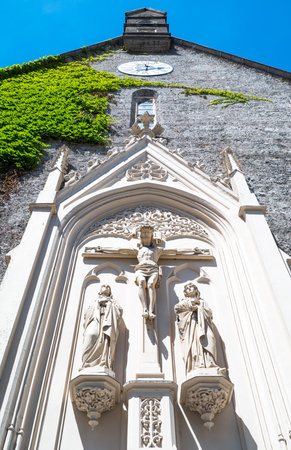 Austria, Salzburg, sacred sculptures on the rear facade of the Blasius church in the old townの写真素材