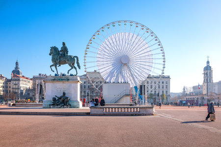 Lyon,  France - December 8, 2016:  Bellecour square with the equestrian monument of King Louis XIV and the big Ferris wheel in the backgroundのeditorial素材