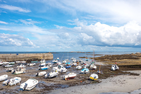 Portivy, France - August 9, 2017: Boats during the low tide in the harbor near the villageのeditorial素材
