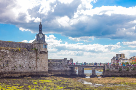 Concarneau, France - August 10, 2017: View of the ramparts and the clock tower of Ville Close (valled city).のeditorial素材