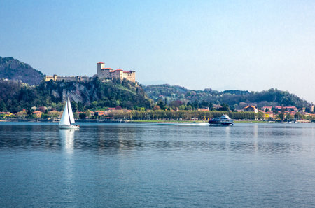 Arona, Italy - April 18, 2013: Panoramic view of the Maggiore lake with the Borromea fortress of Angera in the backgroundのeditorial素材