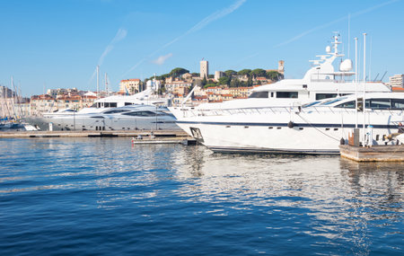 Cannes, France - November 21, 2017:  luxury boats in the marina with Le Sequet old town in tha backgroundのeditorial素材