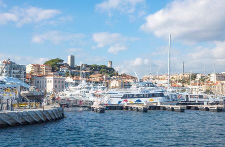 Cannes, France - November 21, 2017: luxury boats in the marina with Le Sequet old town in tha backgroundのeditorial素材
