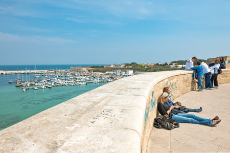 Otranto, Italy - April 11, 2010: Young people on the ramparts over the great harborのeditorial素材