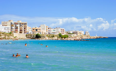 Otranto, Italy - August 28, 2006: People swim in the beautiful sea in front of the historic centerのeditorial素材