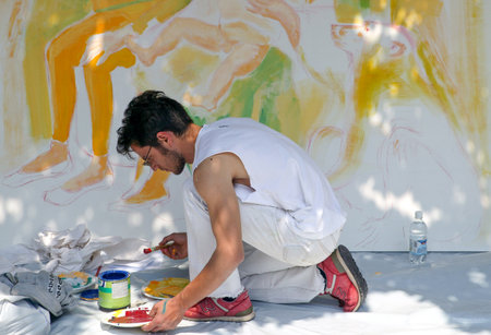 Scicli, Italy - May 16, 2004: Sicily island, a street artist at work in the village centerのeditorial素材