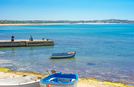 Sampieri, Italy - June 8, 2012: Sicily island,  boats and people in the small fishermen harborのeditorial素材