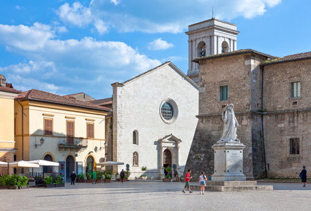Norcia, Italy - May 20,2009 People in St. Benedetto square with the monument , the S.Maria Argentea church and the La Castellina castleのeditorial素材