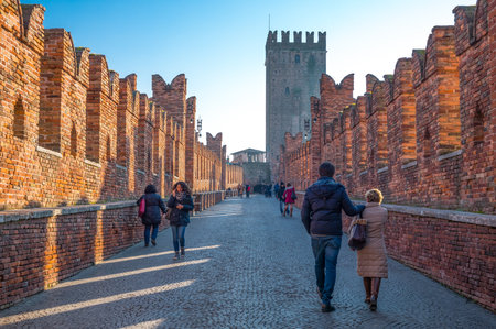 Verona, Italy - December 6, 2013: Visitors crossing the bridge of the Catelvecchio castleのeditorial素材