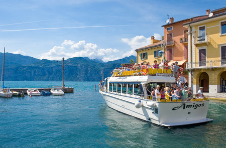 Malcesine, Italy - August 11, 2008: Garda lake, a boat full of tourists leaving the harborのeditorial素材