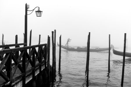 Venice, Italy - December 26, 2014: A gondolier near Riva Degli Schiavoni in a foggy dayのeditorial素材