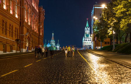 Moscow, Russia - July 15, 2013: Night view of people near the Red Square with the Kremlin and the St Basil's Cathedral in the background