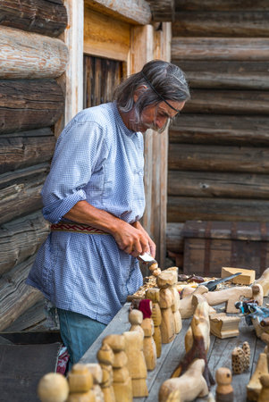 Mandrogi, Russia - July 11, 2013: Karelia Region, a wood craftsman at work in the villageのeditorial素材