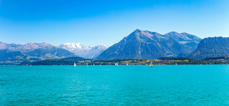 Switzerland , view of the Thun lake with the Swiss Alps in the backgroundの写真素材