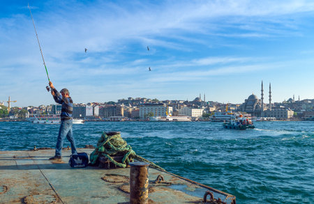 Istambul , Turkey - April 30, 2013:  A fisherman on the Galata bridge quayのeditorial素材