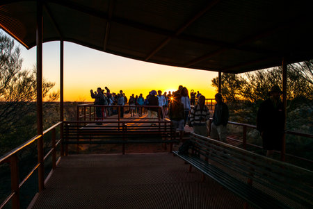Ayers Rock, Australia - October 12,2014: Tourists at sunrise on the lookout area
