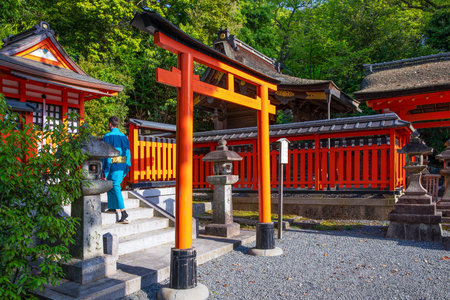 Kyoto, Japan - April 20, 2018: A young man wearin a  kimono, going up the stairs of a shriine of the Fushimi Inari Taisha templeのeditorial素材
