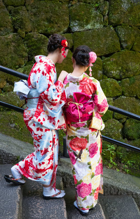 Kyoto, Japan - June 9, 2017:  Two young ladies  in traditional clothing on the lsteps of the Kiyomizu  Templeのeditorial素材