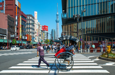 Tokyo, Japan - April 22, 2018: A rickshaw in the Asakusa district with the Tokyo Sky Tree tower in the backgroundのeditorial素材