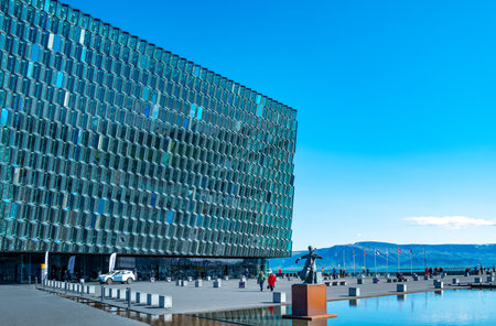 Reykiavik, Iceland - May 31, 2019: The square with monument in front of the  modern crystal and steel architectures of the Harpa Cultural Centerのeditorial素材
