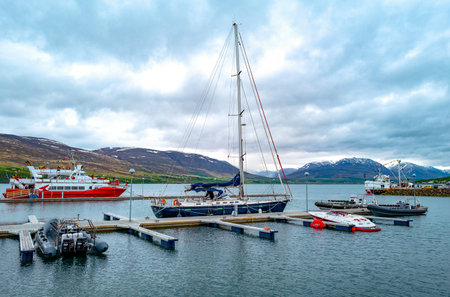 Akureyri, Iceland - June 2, 2019:  Boats and tour boats in the harbor