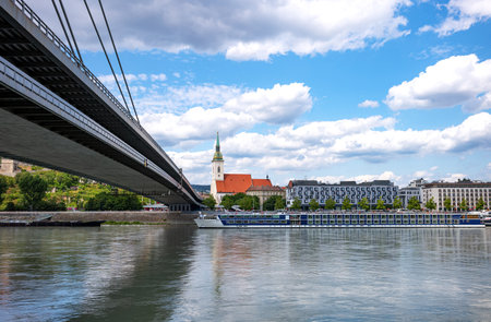 Bratislava, Slovakia, the St. Martin cathedral seen from the Danube river bank with the SNP bridge on the leftの写真素材