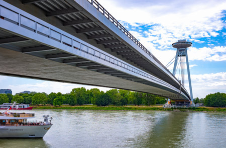 Bratislava, Slovakia - July 9, 2019: The modern SNP bridge seen from the Danube river bankのeditorial素材