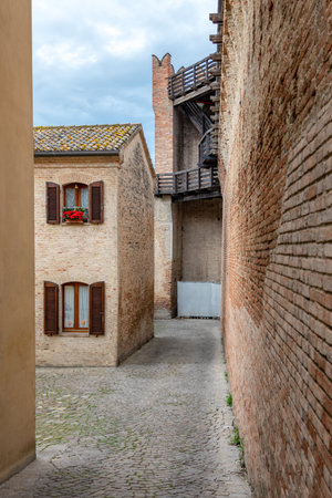 Gradara, Italy, view of the traditional brick houses in front of the medieval wallsの写真素材