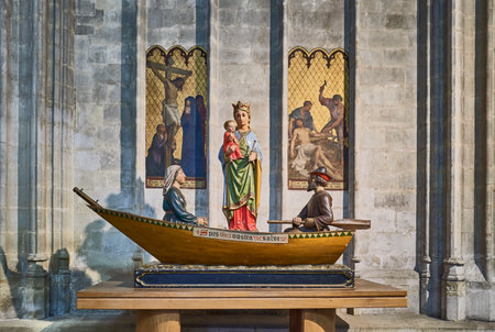 Brussels, Beigium - September 5, 2018: A sacred marble group in front of a colorful stained glass, on the Saints Michael and Gudule Cathedralのeditorial素材