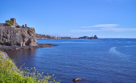 Italy, Aci Castello, panoramic view of the coast with the stacks of the Cyclops marine reserve in the backgroundの写真素材