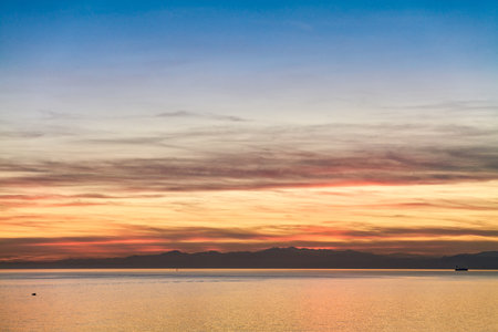 Italy, Genoa, a colorful sunset seen from the harborの写真素材