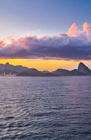 Brazil, Rio De Janeiro, panorama of the famous bay of Rio seen from the sea at sunsetの写真素材