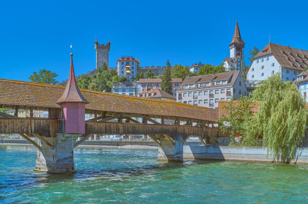 Lucerne, Switzerland, the wooden covered Chapel bridge on the Reuss river with the old town in the backgroundの写真素材