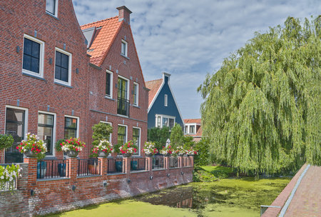 Volendam, Holland, the typical style of the house on a canal in the villageの写真素材