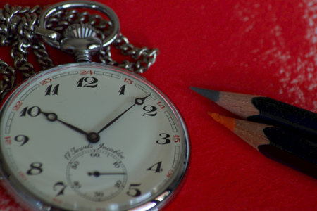 old pocket watch on contrast red backgroundの写真素材