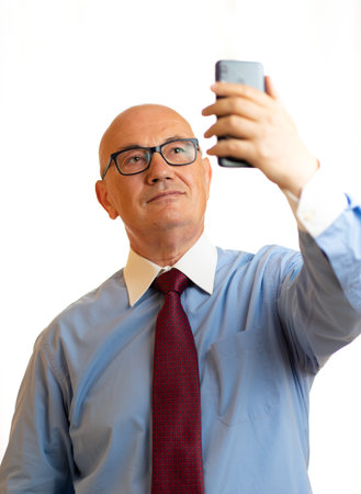 Senior Business Man using a smartphone in a white backgroundの写真素材