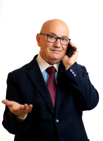 Senior Business Man using a smartphone in a white backgroundの写真素材